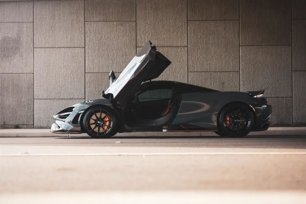 A black and silver car with an open hood